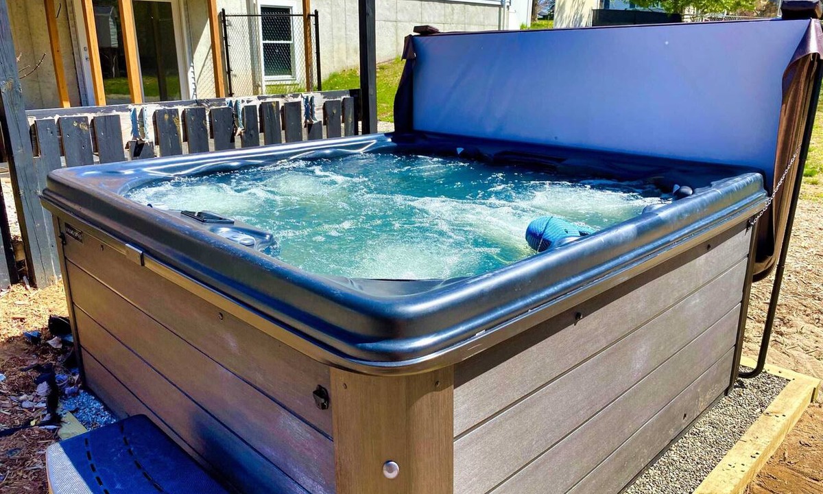 Grawn House | Pet-friendly home with fenced-in yard and hot tub