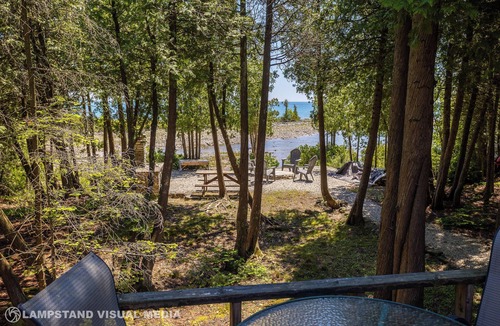Northern Bruce Peninsula House | Breezy Woods Cottage is a private, cedar-lined escape on Georgian Bay. Enjoy rustic charm, a stone fireplace, stunning forest views, and a peaceful waterfront firepit area—just minutes from Tobermory’s top attractions.