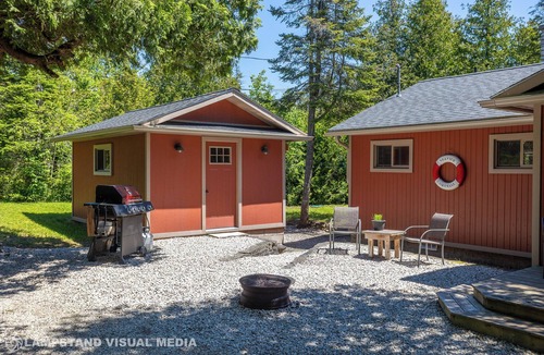 Northern Bruce Peninsula House | Breezy Woods Cottage is a private, cedar-lined escape on Georgian Bay. Enjoy rustic charm, a stone fireplace, stunning forest views, and a peaceful waterfront firepit area—just minutes from Tobermory’s top attractions.
