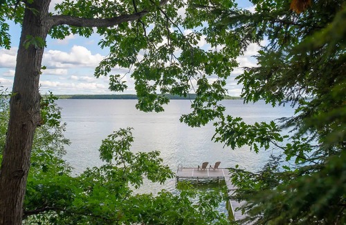 Indian River Cottage | Charming lakefront cottage with large yard, dock, & fire pit - close to downtown