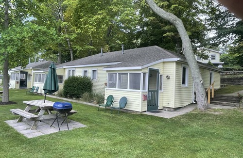 Ludington Cottage | Cottage 4 is a charming 2 bedroom 25’ from your boat dock & Hamlin lake