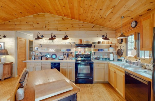 Orland House | Fantastic property on the pond with firepit, wraparound deck, & kayaks