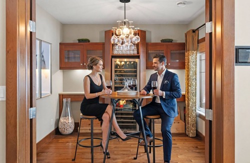 Southwest Edmonton House | Fortunato means "the fortunate one." This former Full House Lottery Dream Home has a private theatre, spa bathroom with soaker tub & heated towel drawer, a wine room, double sided fireplace & a full bar. Lodge luxury in Windermere.