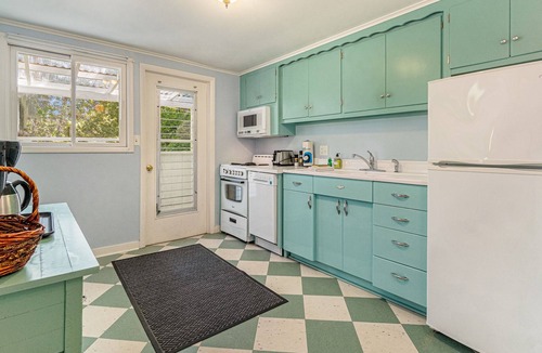 Frankfort Cottage | Lakefront historic cottage with firepit, basketball court access, & kayaks