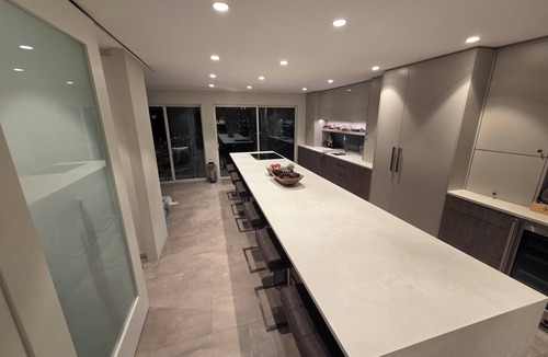 Hastings House | Modern home on a corner lot with large lawn area and patio with hot tub.