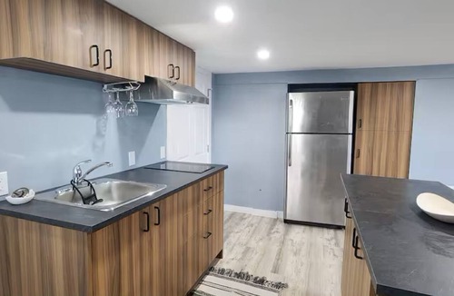 Mount Pearl House | Salt and Spruce private 1 bedroom suite with double bed, kitchen, and laundry