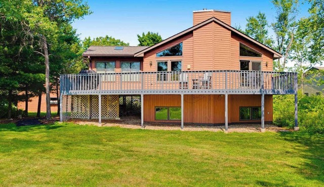Golf course-front home with 2 pools, private beach, boat launches, tennis, grill