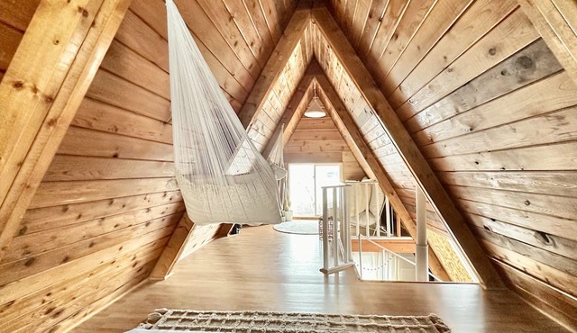 Techni Cabin offers a cozy A-frame blending rustic charm with modern comforts.